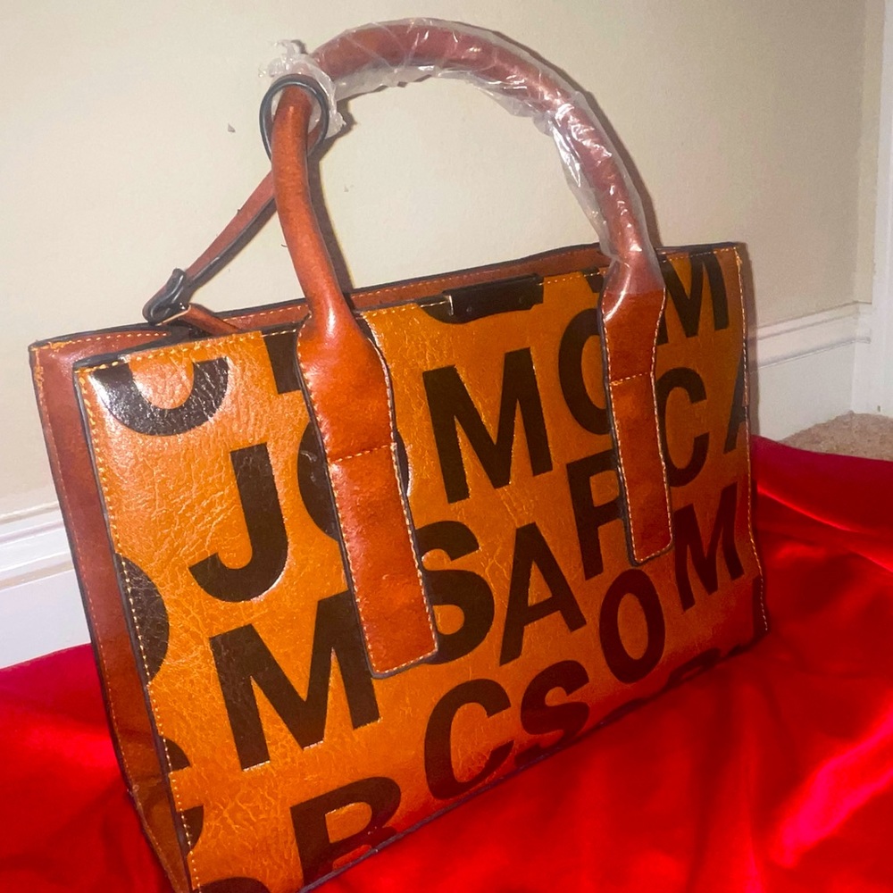 Stylish brown handbag with black lettering